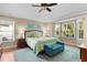 Comfortable bedroom features a ceiling fan, light-colored walls, and a turquoise area rug at 541 Carrera Dr, The Villages, FL 32159