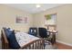 Cozy bedroom with ceiling fan features a desk, chair, and neutral-colored walls at 541 Carrera Dr, The Villages, FL 32159