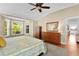 Spacious bedroom boasts a bay window and wood furniture at 541 Carrera Dr, The Villages, FL 32159