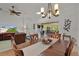 The dining room showcases a wood table, chandelier, and an open layout to other living spaces at 541 Carrera Dr, The Villages, FL 32159