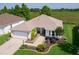 Charming single-story home with a two-car garage, beautifully landscaped front yard and a serene waterfront view at 541 Carrera Dr, The Villages, FL 32159