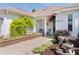 Charming entrance with meticulously maintained landscaping, a small water fountain, and a cozy sitting area at 541 Carrera Dr, The Villages, FL 32159