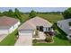 Well-manicured lawn and landscaping accent this home's front exterior and covered entryway at 541 Carrera Dr, The Villages, FL 32159