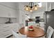 Bright kitchen features white cabinetry, stainless steel appliances, and a breakfast nook perfect for casual dining at 541 Carrera Dr, The Villages, FL 32159