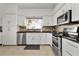 Well-equipped kitchen boasts stainless steel appliances, sleek countertops, and ample natural light for a delightful cooking experience at 541 Carrera Dr, The Villages, FL 32159