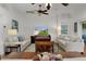 Bright living room with comfortable seating, ceiling fan, and view of the backyard, perfect for relaxation and entertainment at 541 Carrera Dr, The Villages, FL 32159