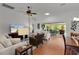 Open-concept living room with hardwood floors, modern decor, and a seamless transition to the patio at 541 Carrera Dr, The Villages, FL 32159
