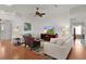 Cozy living room with hardwood floors and an open layout to other living spaces at 541 Carrera Dr, The Villages, FL 32159