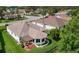 This home features a well-manicured lawn, mature trees, and a rear patio at 541 Carrera Dr, The Villages, FL 32159