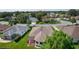 This home features a well-manicured lawn, mature trees, and a rear patio at 541 Carrera Dr, The Villages, FL 32159