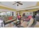 Spacious sunroom with dining and seating areas, ceiling fans, bar area, and expansive outdoor views at 541 Carrera Dr, The Villages, FL 32159
