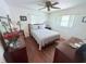 Bedroom with hardwood floors, two windows, and neutral decor at 603 W Seminole Ave, Eustis, FL 32726