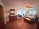 The bedroom includes hardwood floors, a ceiling fan and a window to let in natural light at 603 W Seminole Ave, Eustis, FL 32726