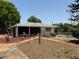 Exterior view of home with sunroom and well kept lawn at 603 W Seminole Ave, Eustis, FL 32726