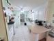 The kitchen is bright with white appliances, tile flooring, and a center island at 603 W Seminole Ave, Eustis, FL 32726