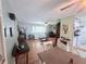 Open-concept living area connecting to the kitchen, featuring hardwood floors and seating at 603 W Seminole Ave, Eustis, FL 32726