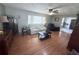 Well-lit living room showcasing hardwood floors, comfortable seating, and ceiling fans at 603 W Seminole Ave, Eustis, FL 32726