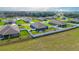 Aerial view showcasing the backyard, screened in lanai, and surrounding properties at 6042 Claystone Way, Mount Dora, FL 32757