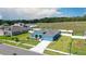 Aerial view of the home with well-manicured lawn and colorful landscaping at 6042 Claystone Way, Mount Dora, FL 32757