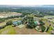 Expansive aerial shot of the community featuring a pool, tennis courts, and surrounding landscape at 6042 Claystone Way, Mount Dora, FL 32757