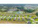 Community aerial view featuring serene pond and rows of beautiful homes at 6042 Claystone Way, Mount Dora, FL 32757