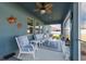 Cozy screened-in porch featuring comfortable seating and a decorative ceiling fan at 6042 Claystone Way, Mount Dora, FL 32757
