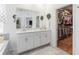 Bathroom featuring a double vanity with a large mirror and a walk-in closet at 6042 Claystone Way, Mount Dora, FL 32757