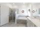 Bathroom featuring a glass-enclosed shower, bathtub, vanity with sink, and neutral-toned tiles at 6042 Claystone Way, Mount Dora, FL 32757