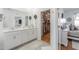 Bathroom with a double vanity, a walk-in closet, and decorative mirrors on the wall at 6042 Claystone Way, Mount Dora, FL 32757