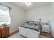 Inviting bedroom with white decor, wooden floors, ceiling fan and a plush rug at 6042 Claystone Way, Mount Dora, FL 32757