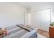 Bedroom with white walls, wood floors, closet and an entrance to another room at 6042 Claystone Way, Mount Dora, FL 32757
