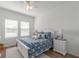 Bright bedroom with hardwood floors, two windows, ceiling fan and a plush rug at 6042 Claystone Way, Mount Dora, FL 32757