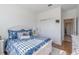 Comfortable bedroom features a white wardrobe, neutral colored rug and wood floors at 6042 Claystone Way, Mount Dora, FL 32757