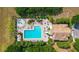 Bird's-eye view of community pool with fountain, sun loungers, and clubhouse at 6042 Claystone Way, Mount Dora, FL 32757