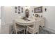 Dining room with a white table, decorative accents, and artwork displayed on the light-colored walls at 6042 Claystone Way, Mount Dora, FL 32757