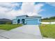 Charming blue single Gathering home with well manicured lawn and landscaping at 6042 Claystone Way, Mount Dora, FL 32757