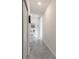 Hallway with neutral-colored tile flooring and doors that lead to other rooms at 6042 Claystone Way, Mount Dora, FL 32757