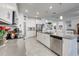 Modern kitchen with stainless steel appliances, gray countertops, and ample white cabinets at 6042 Claystone Way, Mount Dora, FL 32757