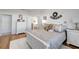 Bedroom featuring a bed with decorative pillows, white dressers, and an ensuite bathroom entrance at 6042 Claystone Way, Mount Dora, FL 32757
