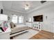Bedroom with a large bed, ceiling fan, natural light, and a dresser with decorative items at 6042 Claystone Way, Mount Dora, FL 32757