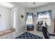 Bright office with neutral paint, ample natural light, and stylish blue accents at 6042 Claystone Way, Mount Dora, FL 32757