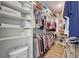 Spacious walk-in closet with custom shelves and hanging rods for optimal storage and organization at 6042 Claystone Way, Mount Dora, FL 32757