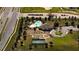 Aerial view showcases a community pool, tennis court, walking paths and lush landscaping at 6203 Sw 93Rd Loop, Ocala, FL 34476