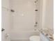 Bright bathroom featuring a white tub-shower combination and granite countertop vanity at 6203 Sw 93Rd Loop, Ocala, FL 34476