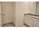 Bathroom featuring a vanity with granite countertop and a door to another room at 6203 Sw 93Rd Loop, Ocala, FL 34476