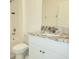Modern bathroom featuring granite countertops, a white cabinet, and a tub with shower at 6203 Sw 93Rd Loop, Ocala, FL 34476
