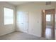 Neutral bedroom with a carpeted floor, double door closet, and a window with blinds at 6203 Sw 93Rd Loop, Ocala, FL 34476