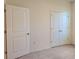 Bedroom featuring a carpeted floor, white walls, and a double-door closet for storage at 6203 Sw 93Rd Loop, Ocala, FL 34476