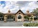 Community entrance featuring stone accents, decorative lighting, and gated access for added security at 6203 Sw 93Rd Loop, Ocala, FL 34476