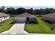 Beautiful single-story home with lush green lawn and a driveway at 6203 Sw 93Rd Loop, Ocala, FL 34476